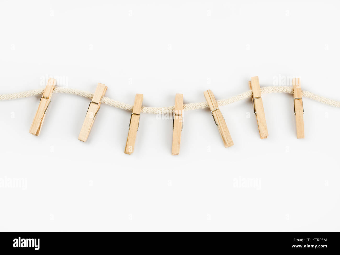 Clothes clips on a rope isolated on white background - loundry peg on string isolated Stock Photo