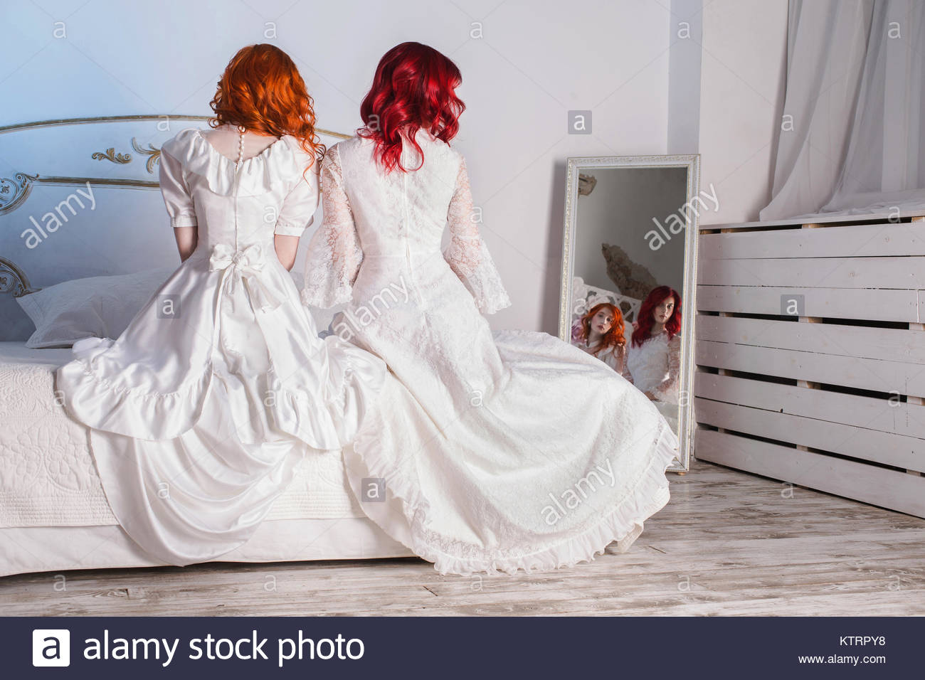 Two Beautiful Girls With Red Hair In A Beautiful White Wedding