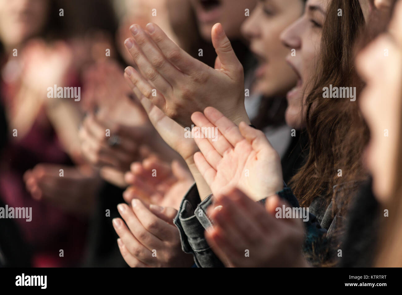 Young protesters clapping and demonstrating during a general strike demostration in Athens, Greece. Stock Photo