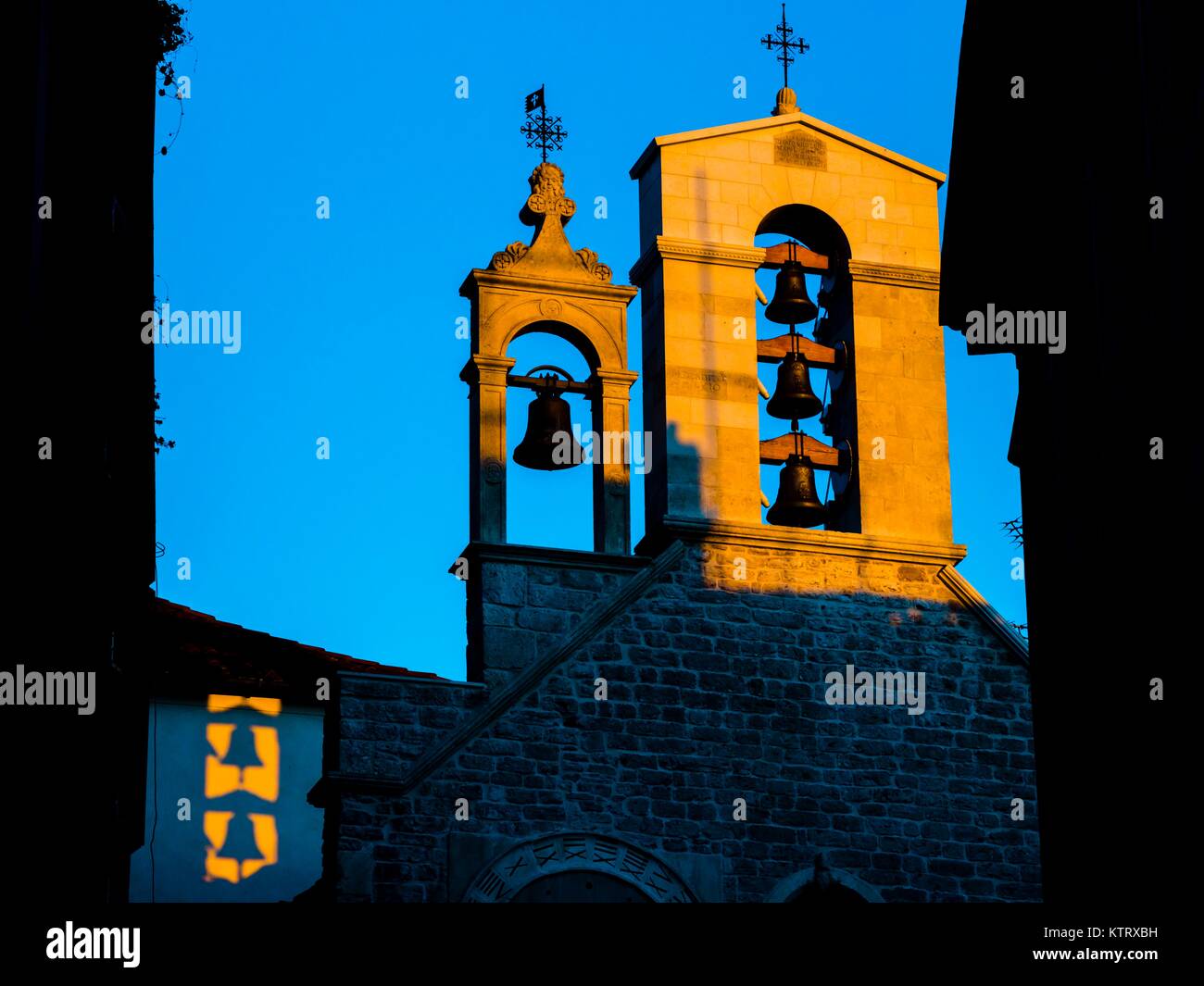 Sunset in old-town Sibenik in Croatia multiple bells ringing on church Stock Photo
