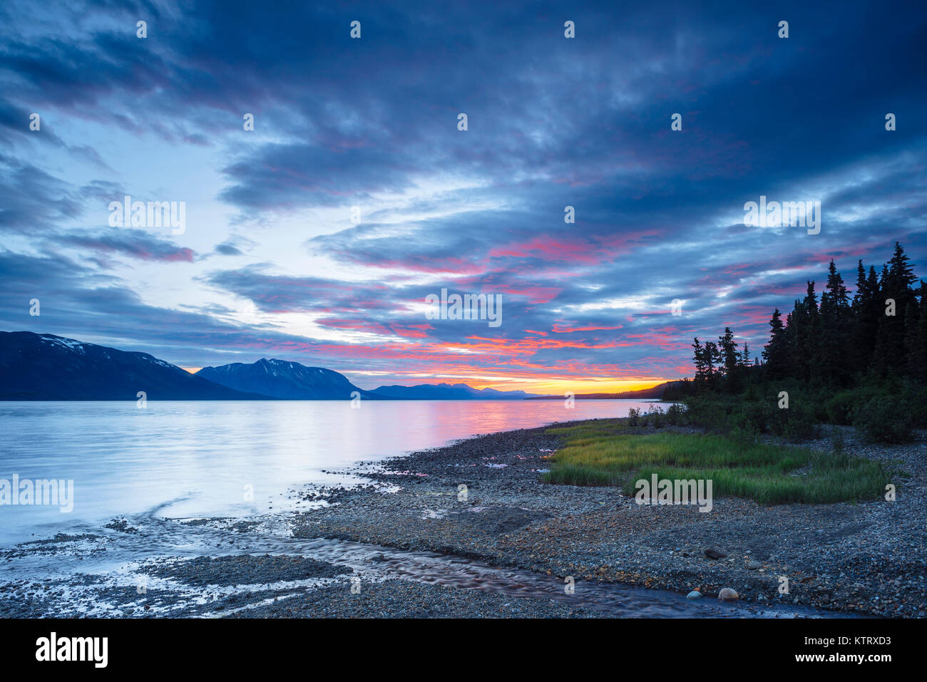 A sunset view of Atlin Lake from Warm Bay Recreation Site, near Atlin, British Columbia, Canada Stock Photo
