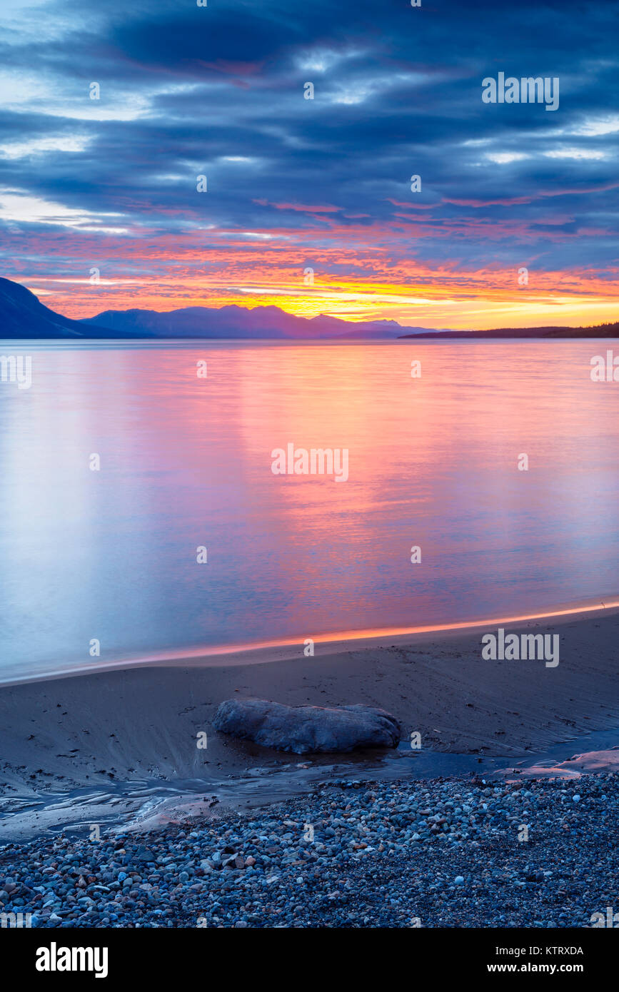 A sunset view of Atlin Lake from Warm Bay Recreation Site, near Atlin, British Columbia, Canada Stock Photo