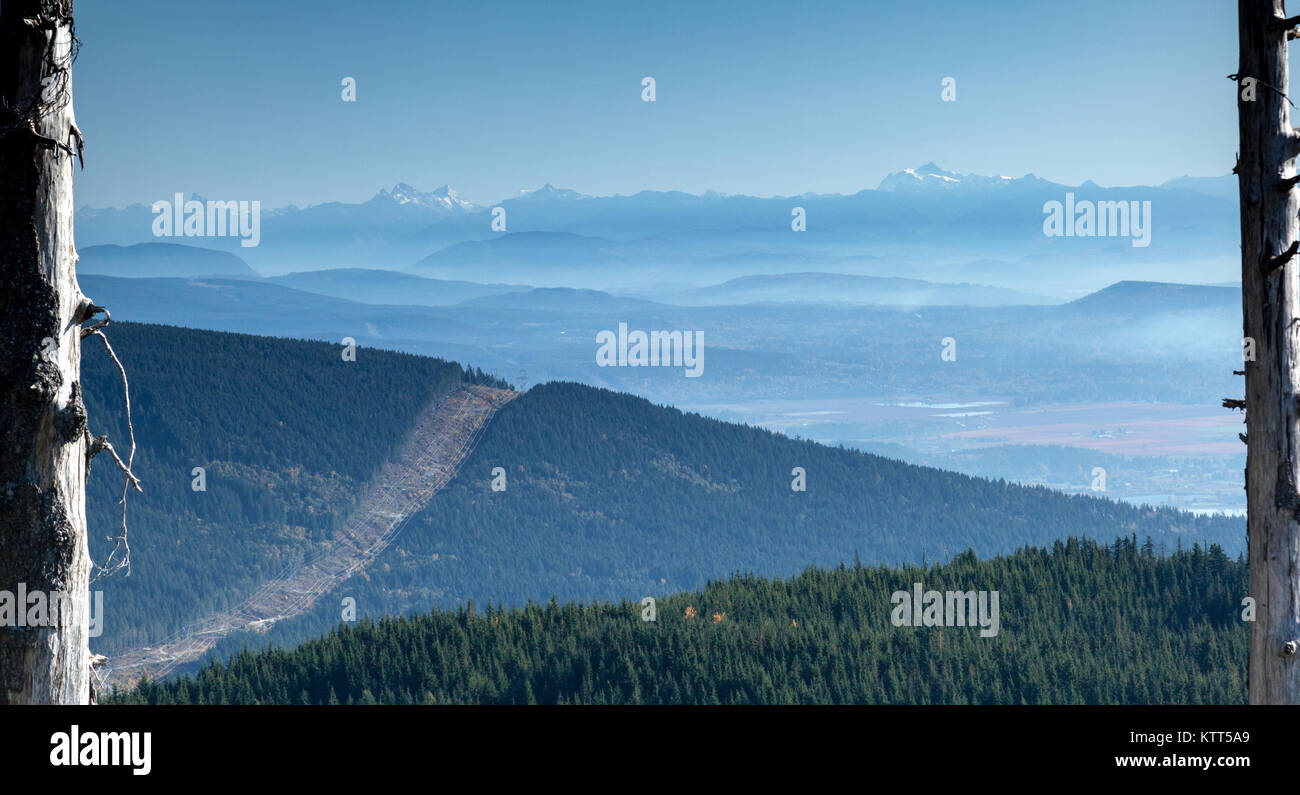 Coquitlam river valley and Cascade Mountains view between power lines, British Columbia, Canada Stock Photo