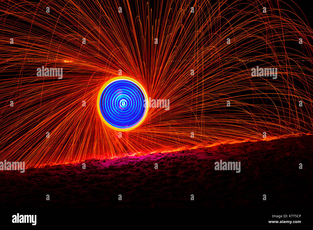 Man fire dancing with steel wool Stock Photo