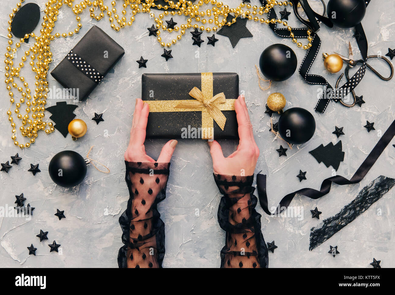 Woman's hands holding a Christmas gift Stock Photo - Alamy