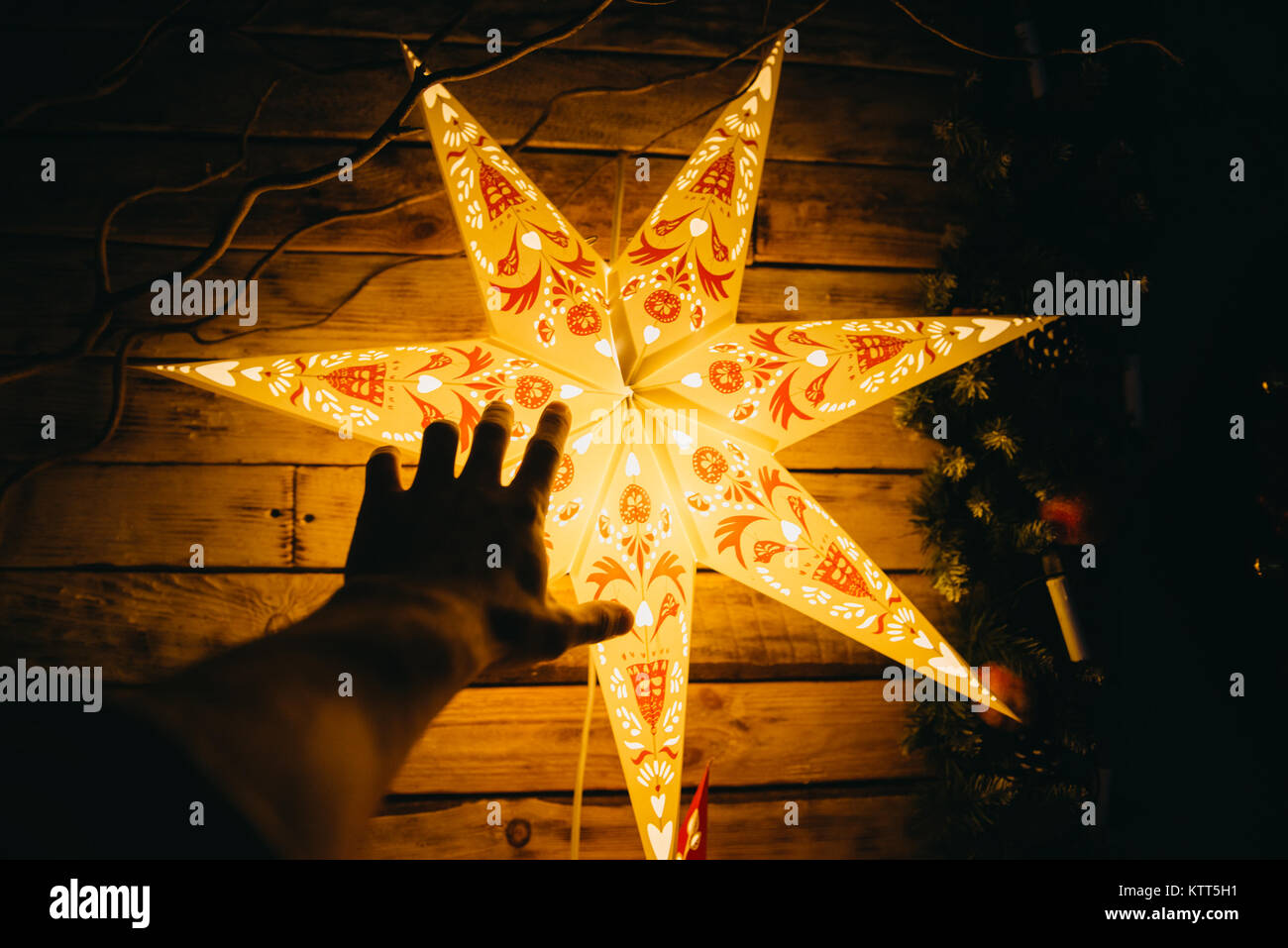 Human hand reaching for an illuminated star Stock Photo