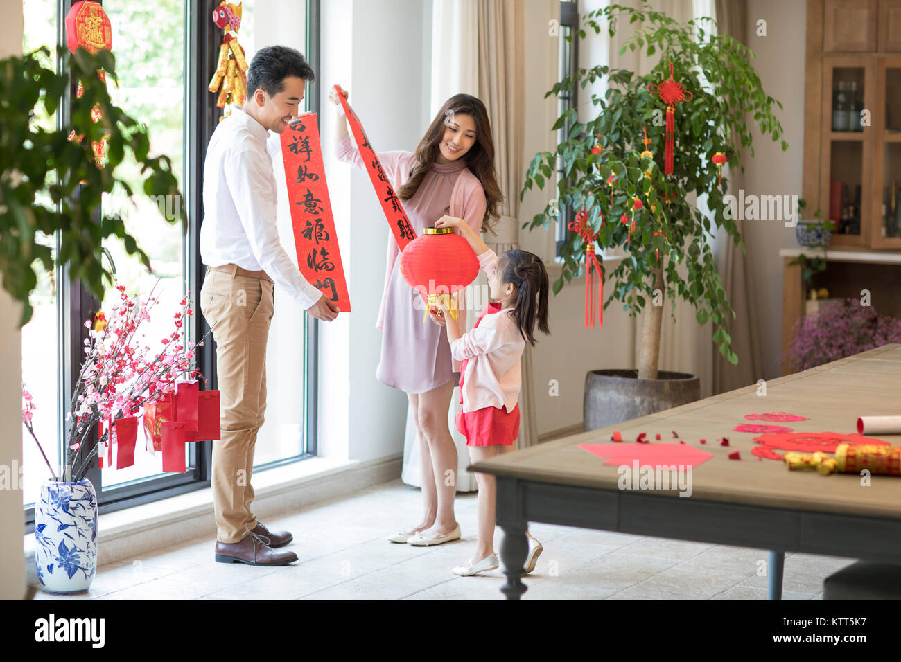 Happy family decorating their house for Chinese New Year Stock ...