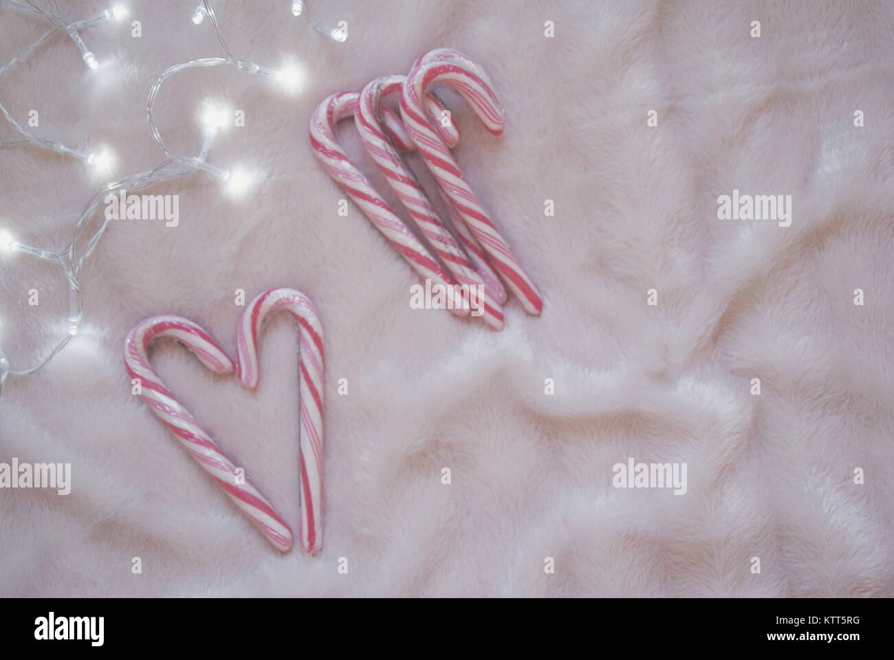 Candy canes in a heart shape with fairy lights Stock Photo Alamy