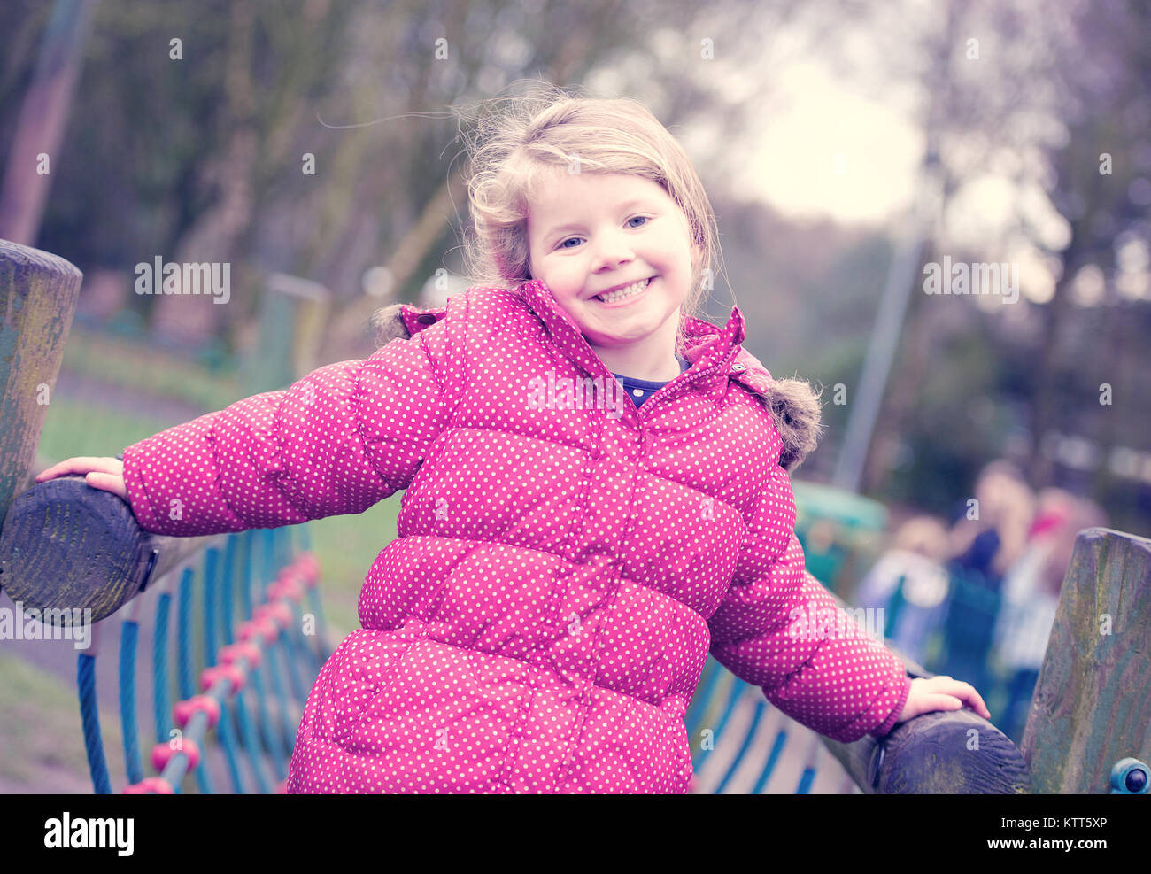 Girl on a climbing frame in a playground Stock Photo