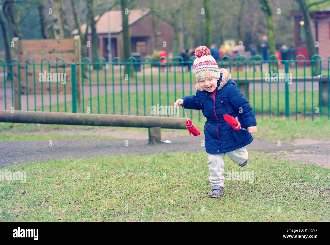 Girl running in a public park Stock Photo