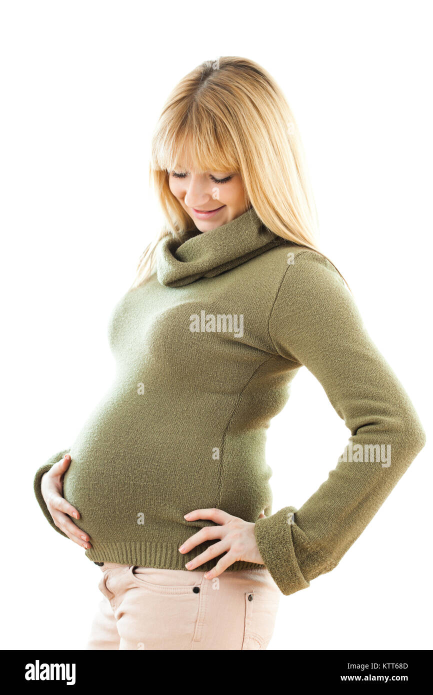 Happy pregnant woman holding her stomach and smiling Stock Photo - Alamy