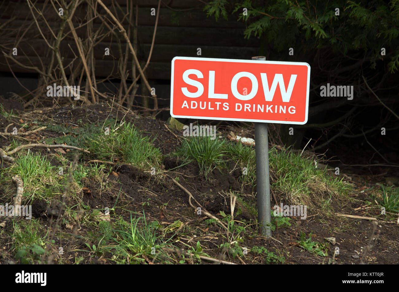 Slow, Adults drinking sign outside the Wallace Arms, Featherstone, Northumberland Stock Photo