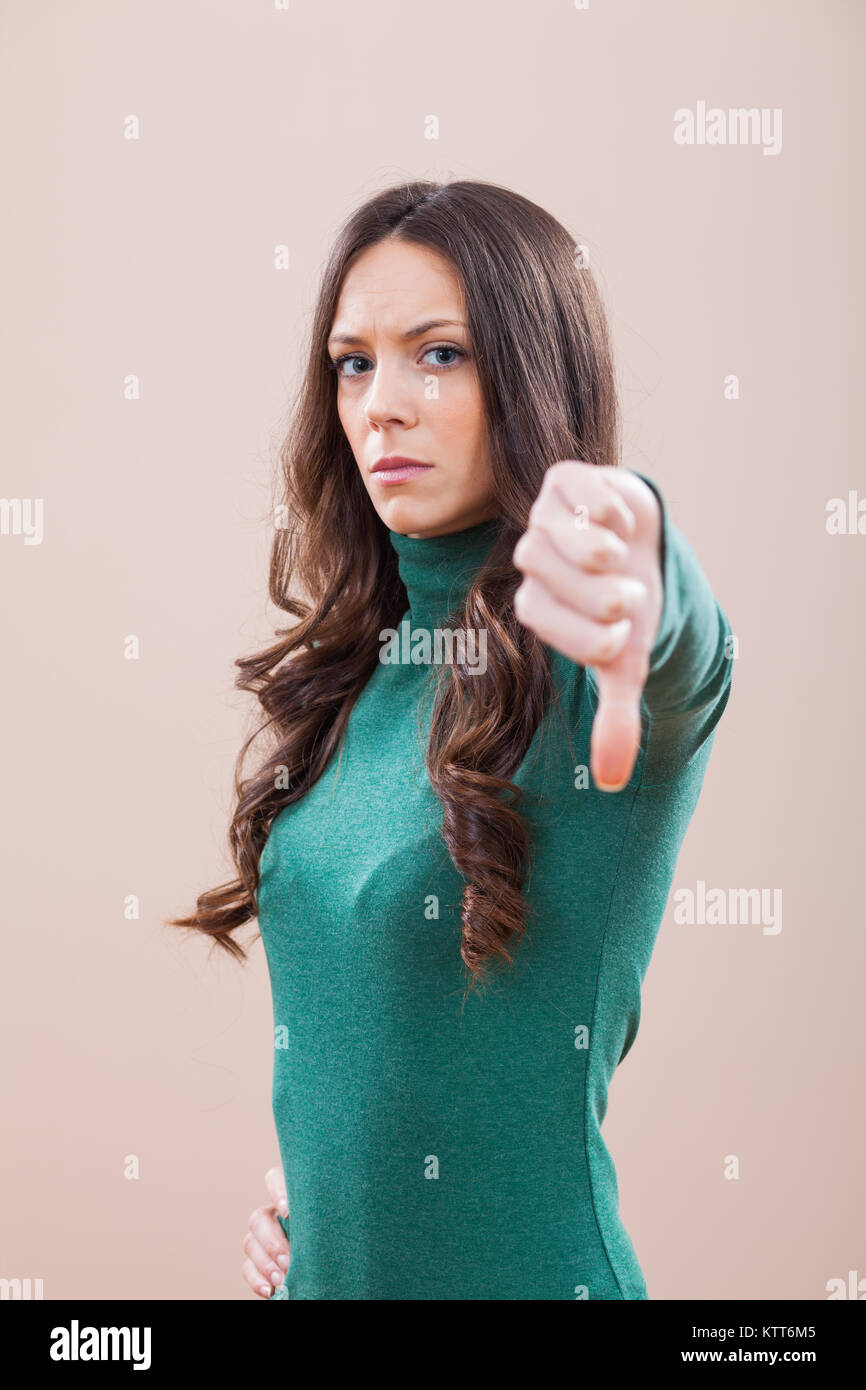 Portrait of displeased women who is showing thumb down Stock Photo