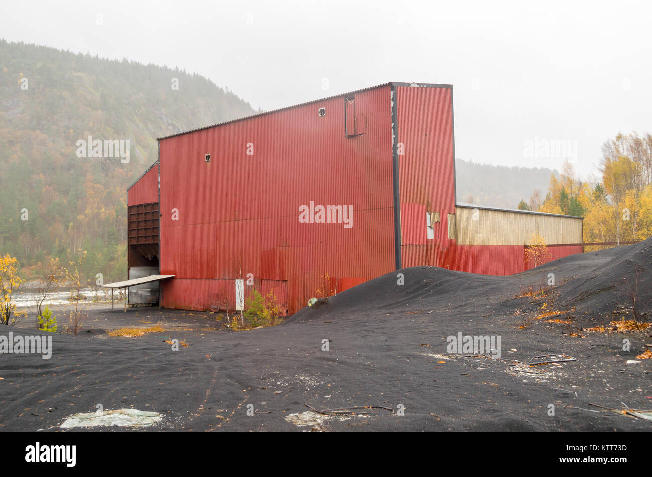 Postindustrial landscape of abandoned nickel smelter in Evje, Norway, during foggy rainy day of late autumn. Stock Photo