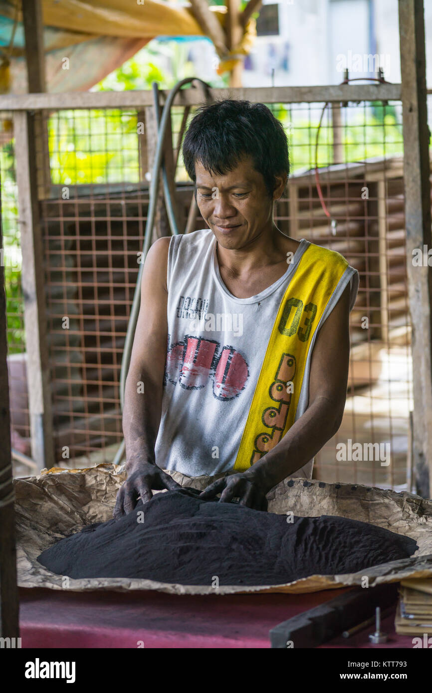 A man mixing gunpowder during the process of manufacturing fireworks