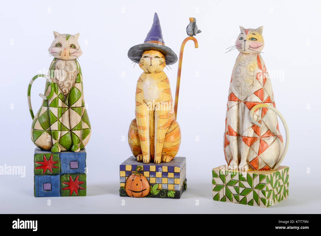 Three colorful wooden cats isolated on white Stock Photo - Alamy