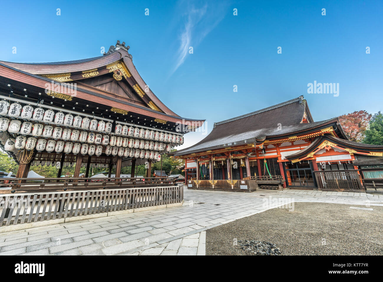 Honden (Main Hall) and Maidono (Dance Hall)  with hanging Lanterns (Chouchin) with name of donors. Yasaka Shinto Shrine at Sunrise.Kyoto, Japan Stock Photo