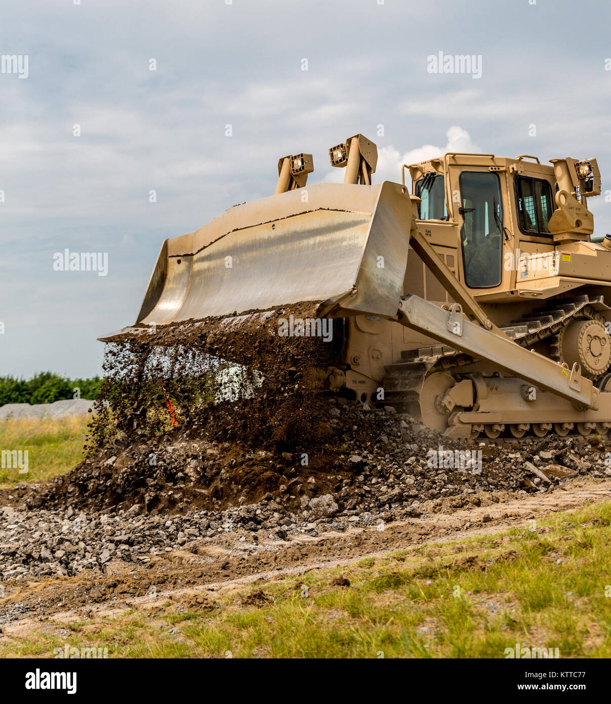 New York Army National Guard Soldiers with the 827th Engineer Company, 204th Engineer Battalion, tear apart and regrade a road during their annual training at Fort Drum, N.Y., July 19th, 2017. The road is one of four construction projects the battalion ran during its time at Fort Drum, which allowed the Soldiers to hone their skills while creating lasting construction projects for the post. (U. S. Army National Guard photo by Sgt. Harley Jelis) Stock Photo