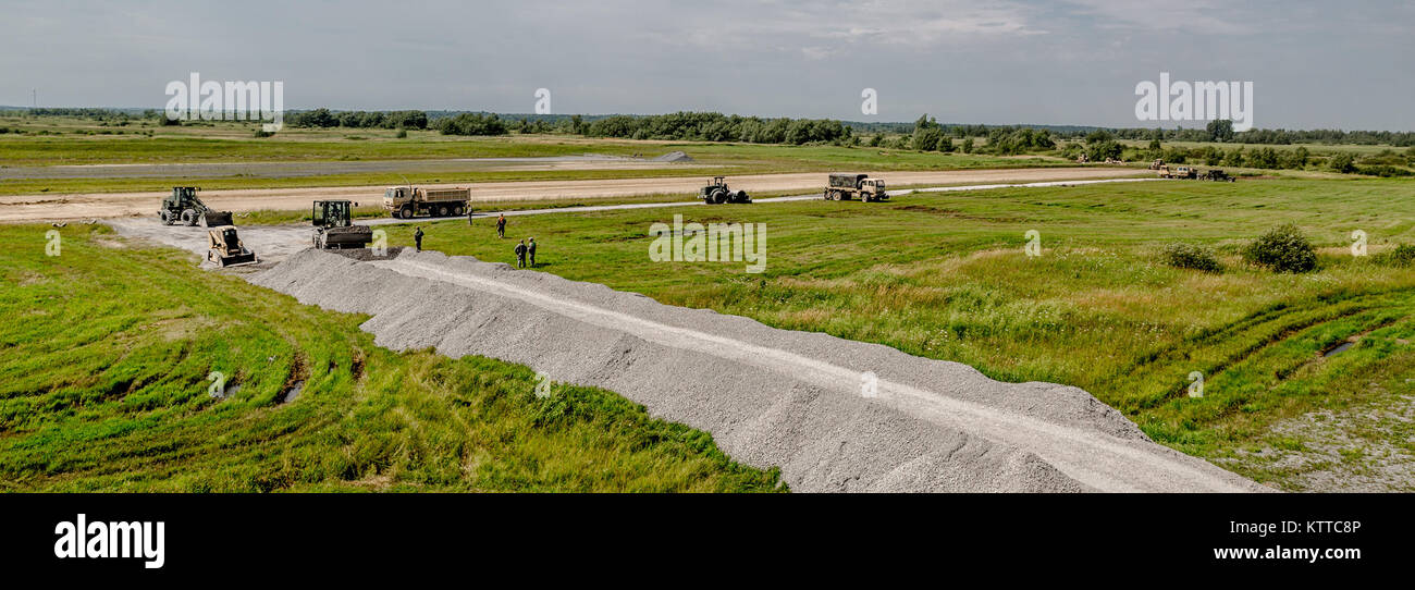 New York Army National Guard Soldiers with the 152nd Engineer Support Company, 204th Engineer Battalion, resurface a forward land strip for C-130 planes and build a new road during their annual training at Fort Drum, N.Y., July 19th, 2017. The landing strip is one of four construction projects the battalion ran during its time at Fort Drum, which allowed the Soldiers to hone their skills while creating lasting construction projects for the post. (U. S. Army National Guard photo by Sgt. Harley Jelis) Stock Photo