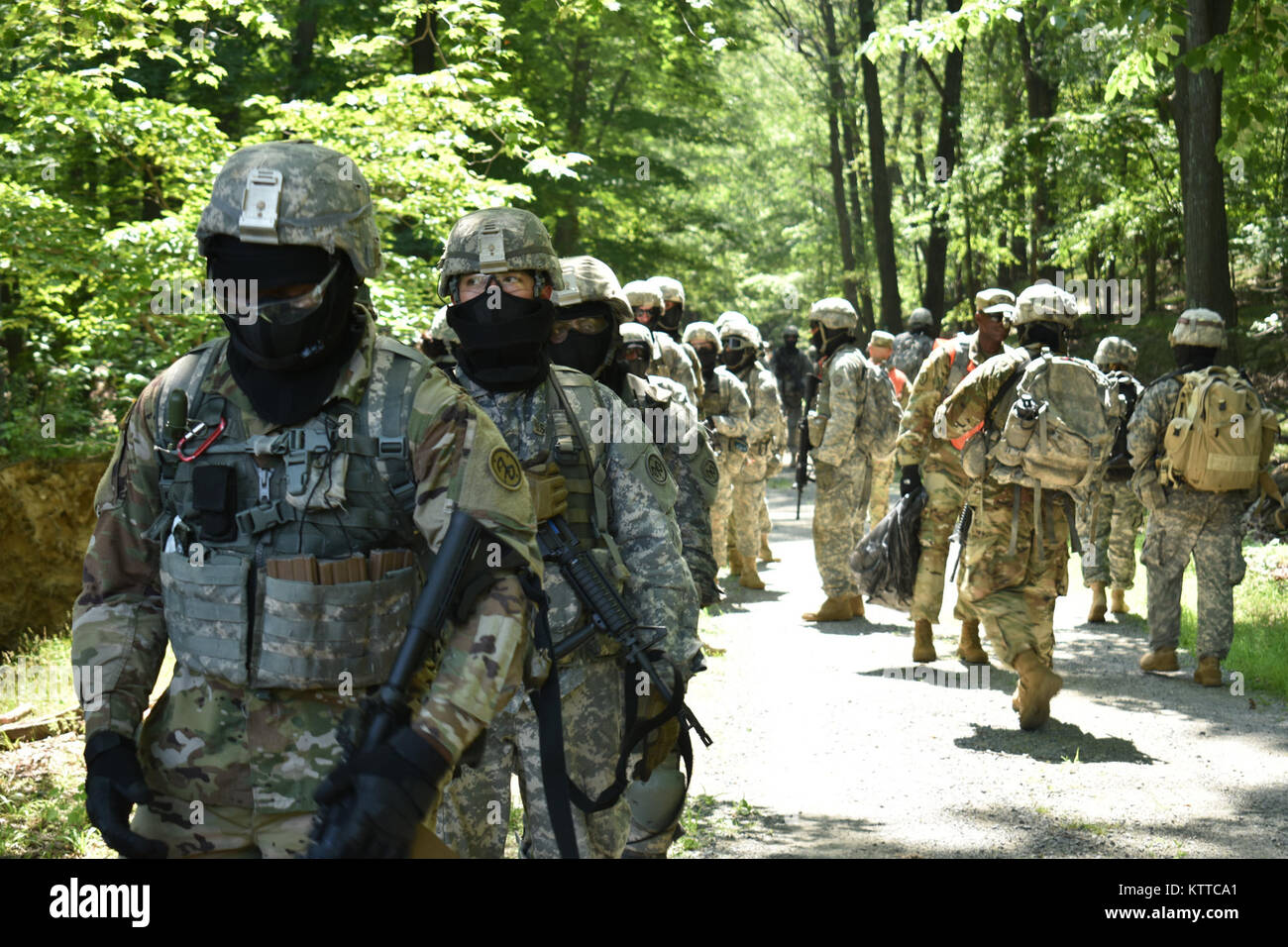 N.Y. Army National Guard Soldiers, students in the Future Leader Course, move to their next training location, on the Camp Smith Training Site, Cortlandt Manor, N.Y., July 20, 2017. The students were conducting a Field Training Exercise which taught them how to move as a unit in a hostile area, make fast and effective decisions, and take control of a situation after a loss of leadership. (U.S. Army National Guard photo by Pfc. Andrew Valenza) Stock Photo