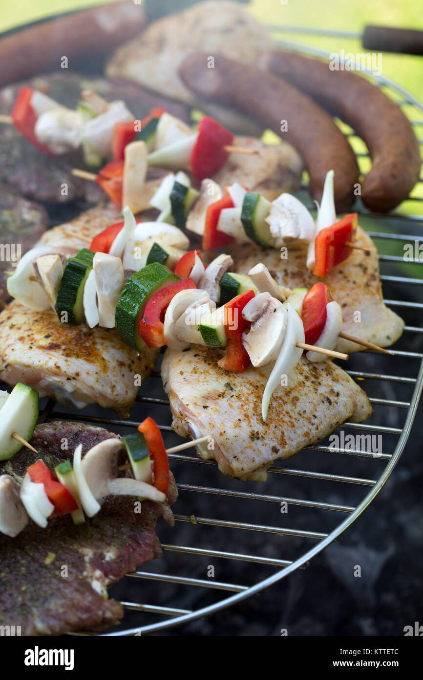 barbecue with delicious grilled meat and vegetables on grill Stock ...