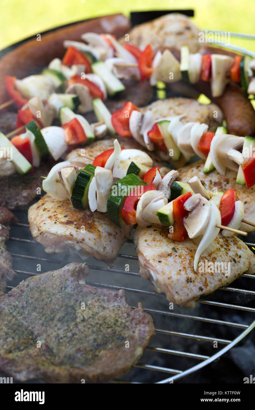 barbecue with delicious grilled meat and vegetables on grill Stock ...