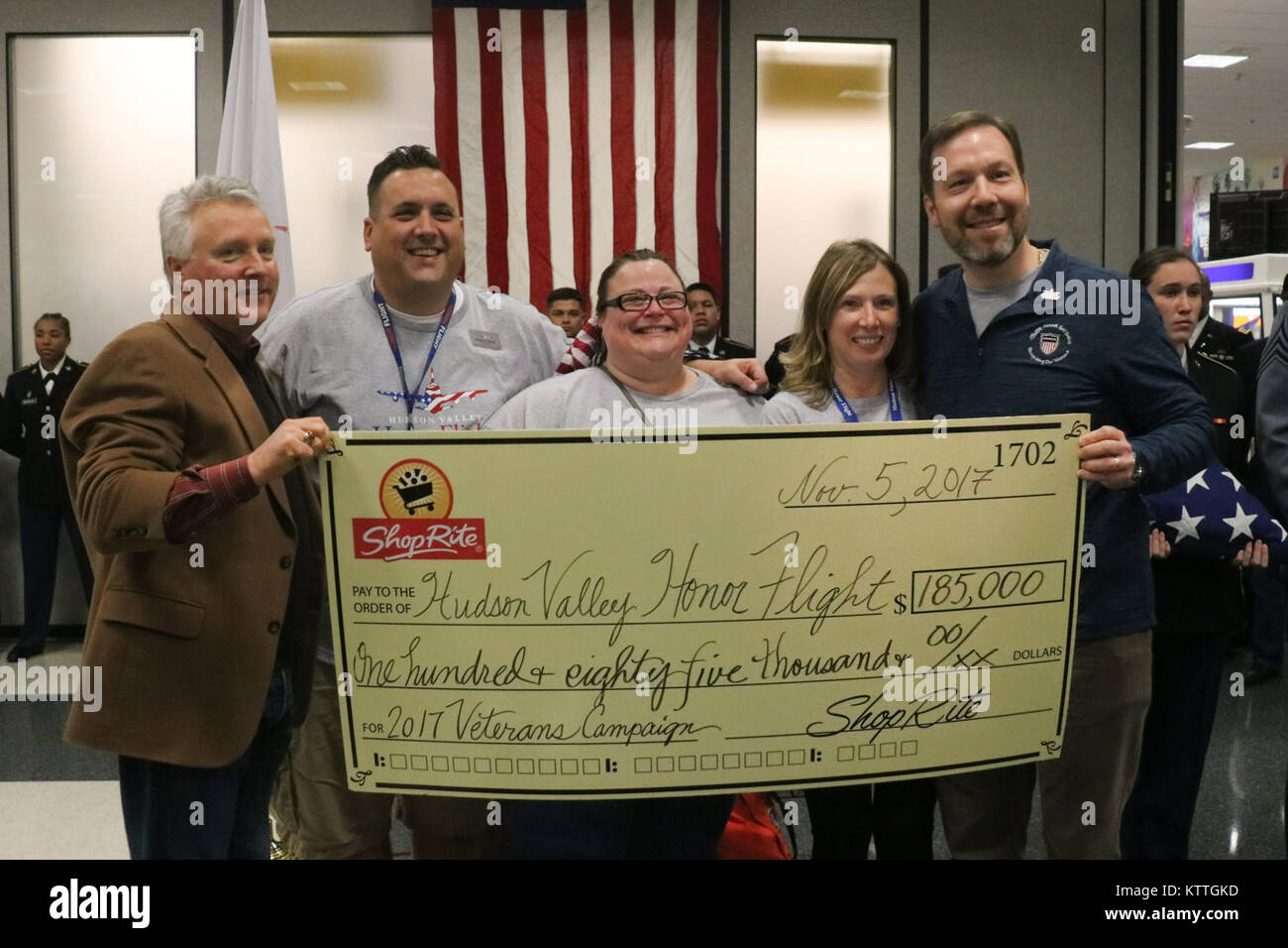 Executive Officers from Hudson Valley Honor Flight (HVHF) receive a donation from ShopRite representatives November 4, 2017 at Stewart International Airport, Newburgh, NY. Hudson Valley Honor Flight is a non-profit organization that provides flights for veterans to Washington, D.C., to visit the memorials that honor them. Pictured (L-R) are ShopRite President Brett Wing, HVHF Chairman Frank Kimler, HVHF Executive Director Beth Vought, HVHF Safety Coordinator Jennifer DeFRancesco, and ShopRite Vice-President of Operations Tom Urtz. (U.S. National Guard photo by Master Sgt. Lee C. Guagenti) Stock Photo