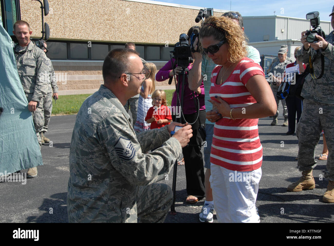 On August 29, 2011 family members and loved ones of the New York Air National Guard's 107th Airlift Wing's based in Niagara falls  welcomed the first wave of Airmen as they arrive home from a 90 day deployment to Afghanistan. Master Sergeant Vincent Kalota purposes to his fiancee with all the family looking on and she said yes. (Air Force Photo/TSgt Catherine Perretta) Stock Photo