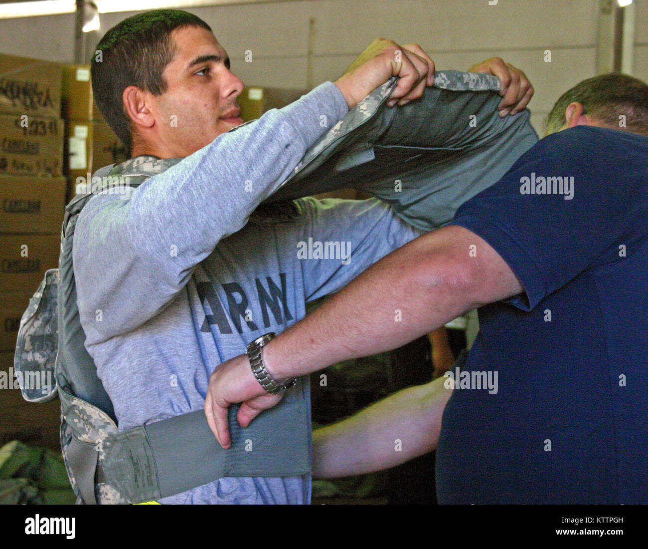 Pvt. Mark A. Fisher of Columbus, Ohio, military police for Headquarters and Headquarters Company, Special Troops Battalion, 37th Infantry Brigade Combat Team, gets fitted for his Improved Outer Tactical Vest on Oct. 25, 2001, at Camp Shelby Joint Forces Training Center, Miss., in preparation for the 37th's upcoming deployment to Afghanistan in support of Operation Enduring Freedom. (Ohio National Guard photo by Sgt. Kimberly Lamb) (Released) Stock Photo