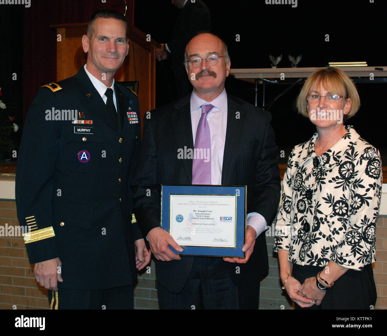 NORTH COLONIE -- Major General Patrick Murphy, New York National Guard Adjutant General (right) poses with D. Joseph Corr (center), Superintendant of the North Colonie Central School District and Karen Lettko, Colonie School District teacher after presenting Corr with the Employer Support of the Guard and Reserve Patriot Award, Nov 2.  Corr received the award for his continuous support to the National Guard.  Lettko, whose husband is currently serving as the deputy commander in Guantanamo Bay, Cuba submitted Corr for the award. (Photo by John Willsey/RELEASED) Stock Photo