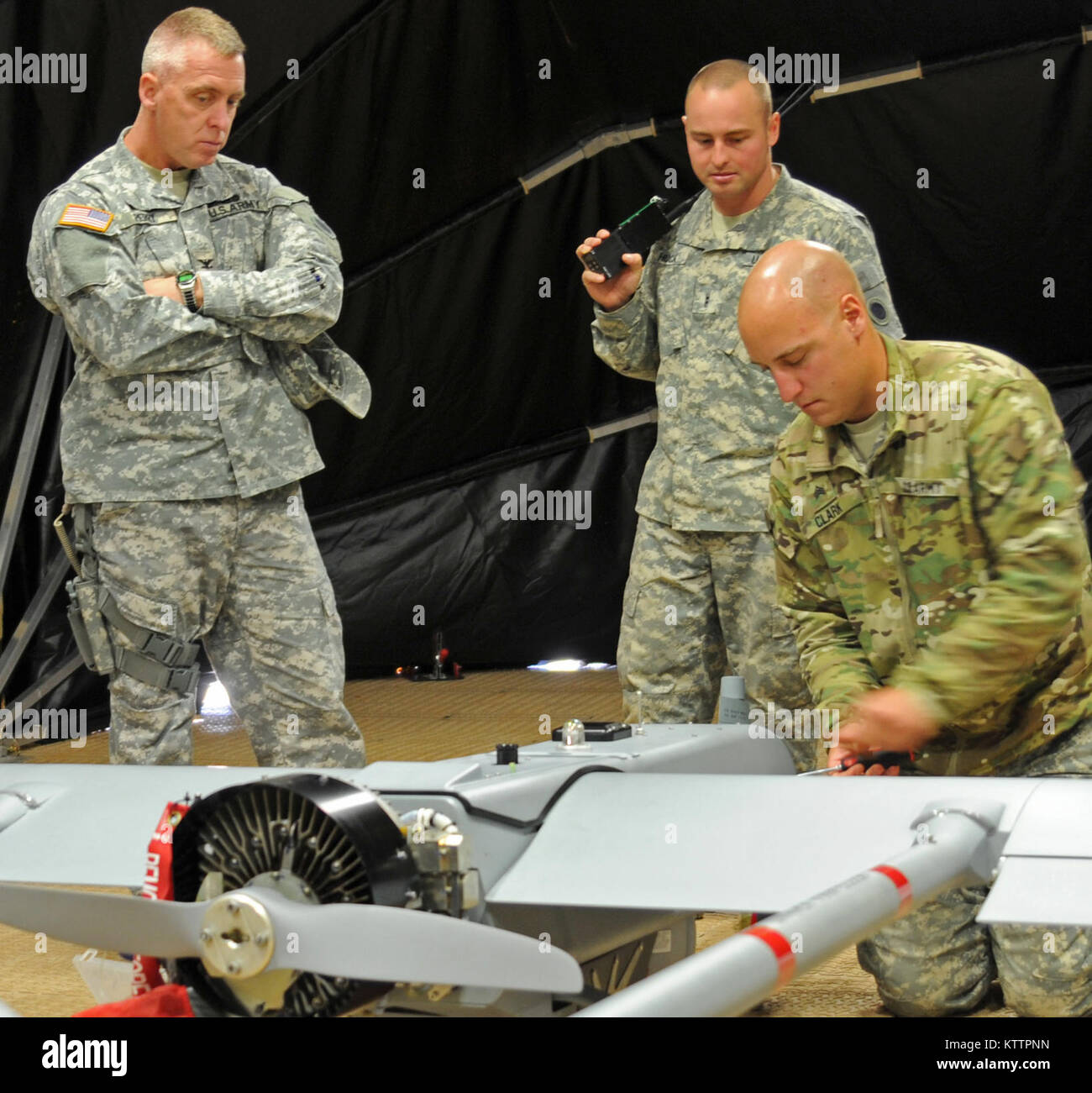 Col. James Perry, brigade commander for the 37th Infantry Brigade Combat Team observes Sgt. Sean Clark, unmanned aerial vehicle maintainer assigned to Headquarters and Headquarters Company, 37th IBCT, as Chief Warrant Officer 2 James P. Huck IV, UAV operator also assigned to HHC 37th IBCT, explains the Shadow 200 UAV's capabilities before a flight demonstration at Camp Shelby Joint Forces Training Center, Miss., Nov. 5, 2011. The UAV will be used by the 37th IBCT during their upcoming deployment to Afghanistan in support of Operation Enduring Freedom. (37th IBCT photo by Sgt. Kimberly Lamb) (R Stock Photo