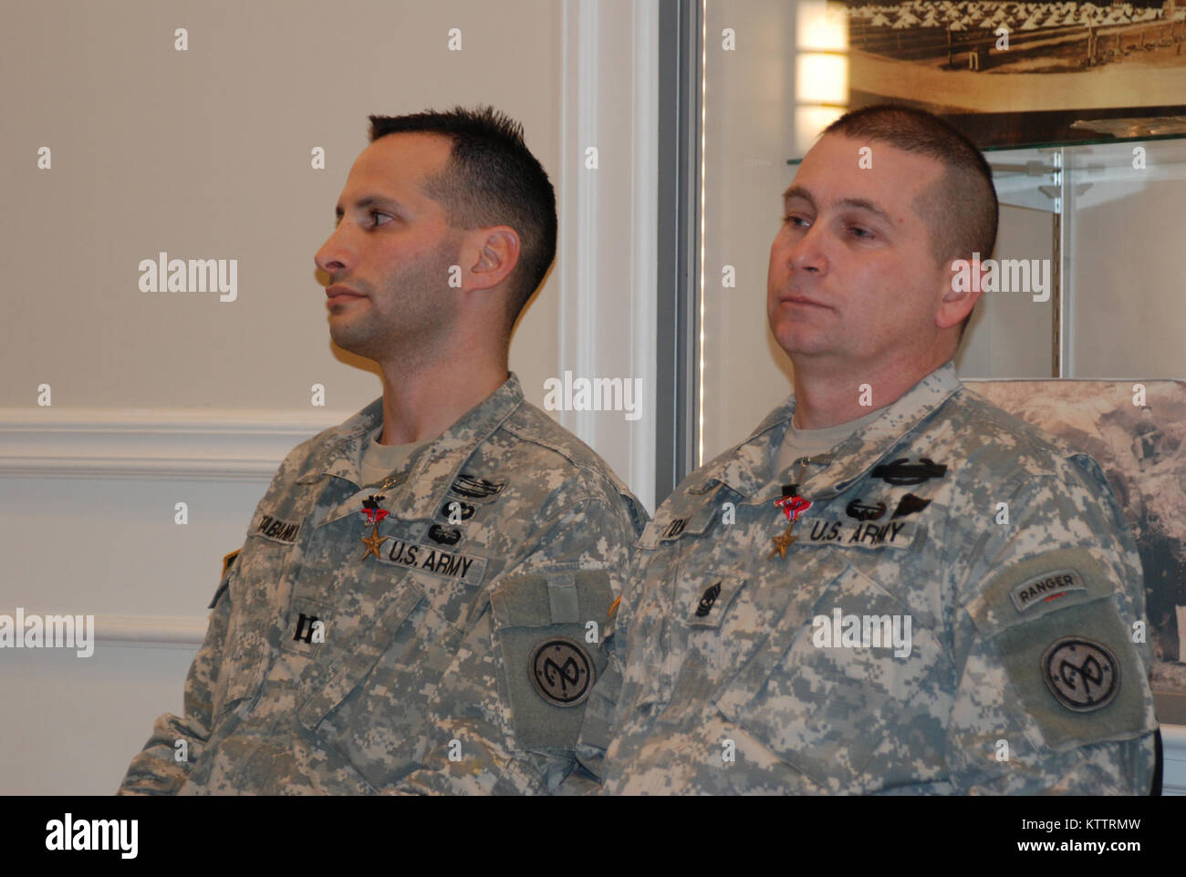 CAMP SMITH TRAINING SITE, CORTLANDT MANOR, N.Y. – New York Army National Guard Soldiers Capt. Shawn Tabankin and Sgt. Major Arnold Stone listen to comments from their brigade commander following the presentation of the Bronze Star medal here Jan. 6.  The two received their medals for service in Iraq in 2004.  The processing of their awards took seven years as the former platoon leader and platoon sergeant devoted their time and energy to correct award submissions of their assigned Soldiers first. Photo by Lt. Col. Richard Goldenberg, New York Army National Guard. (RELEASED) Stock Photo