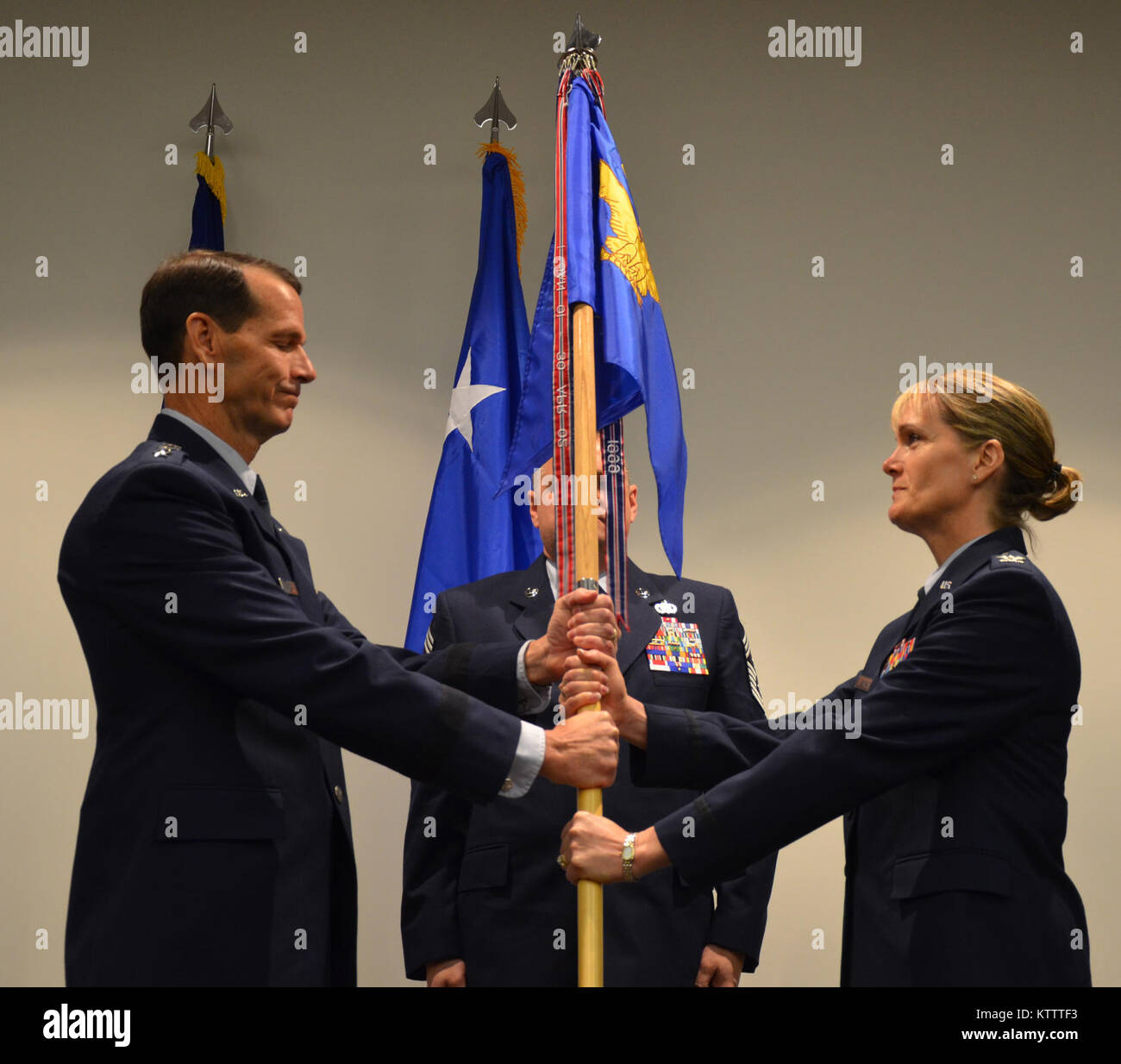 Col. Dawne L. Deskins receives the Eastern Air Defense Sector guidon Friday morning from Lt. Gen. Stanley E. Clarke, Commander, Continental U.S. North American Aerospace Defense Command Region (CONR)/1st Air Force (Air Forces Northern).  The passing of the guidon symbolizes Col. Deskins assumption of the unit’s command. Also pictured is Command Chief Master Sergeant Richard King, the Command Chief Master Sergeant of the New York Air National Guard.   Photo by Maj. Joakim Hansson Stock Photo