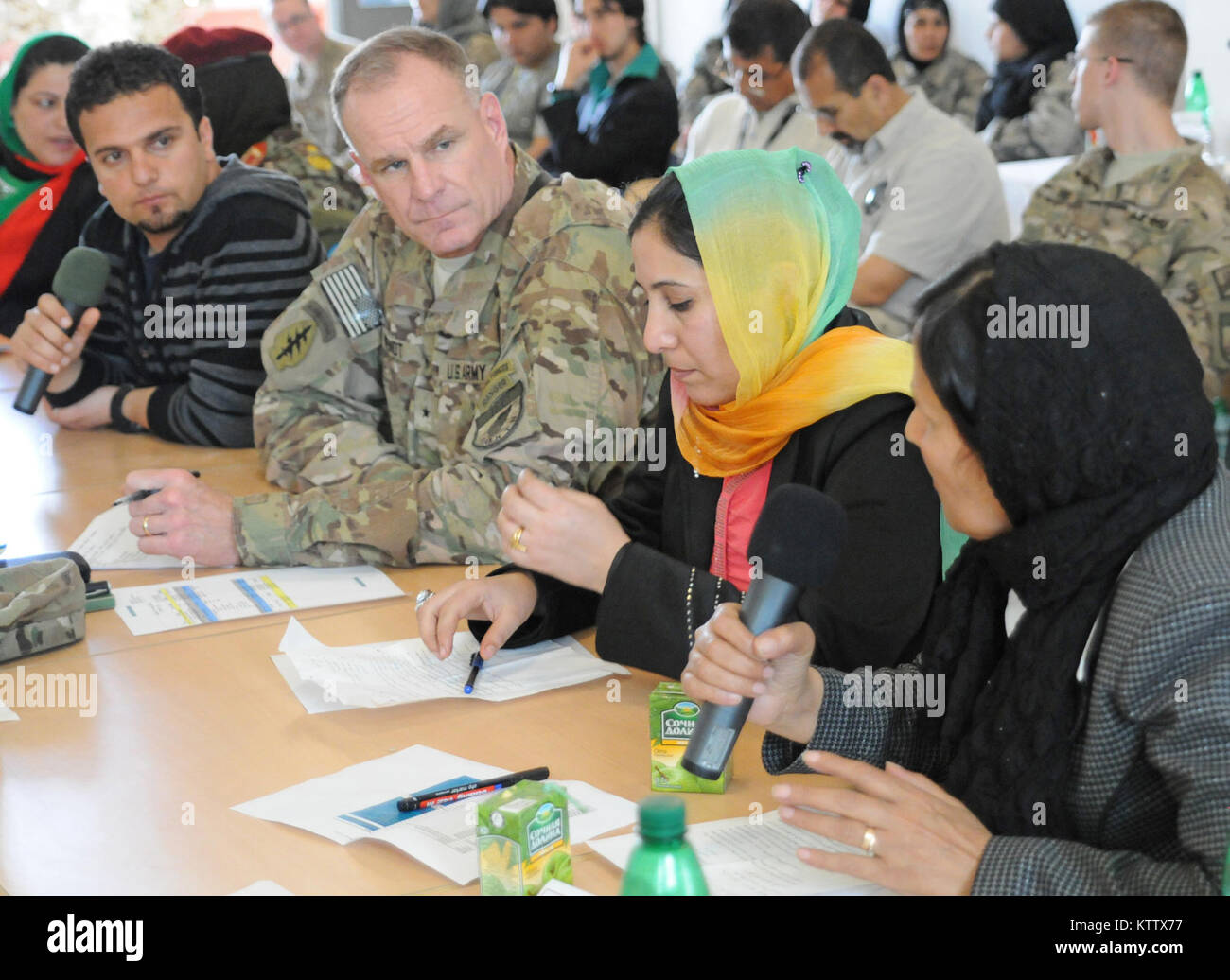 Brig. Gen. Eric P. Wendt, Deputy Commander for the International Security Assistance Force, Regional Command-North, listens to the request of a female Afghan leader during a shura that was held at Camp Marmal, Balkh Province, Afghanistan, March 28, 2012. The shura was held to allow Afghan female leaders an opportunity to present projects to the leaders of Regional Command-North. (37th IBCT photo by Sgt. Kimberly Lamb) (Released) Stock Photo