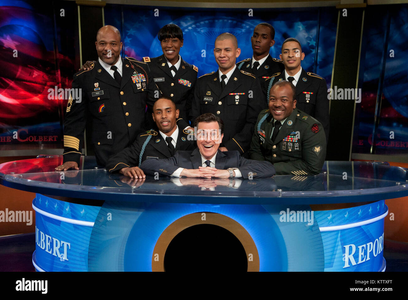 Soldiers and Family members of the 727th Military Police Law and Order Detachment, the369th Sustainment Brigade and 1st Battalion, 69th Infantry Regiment gather around Stephen Colbert, host of The Colbert Report after his conversation with first lady Michelle Obama, on the first anniversary promoting Joining Forces,  a national initiative led by the first lady and Dr. Jill Biden that mobilizes all sectors of society to give our service members and their families the opportunities and support they have earned. Stock Photo