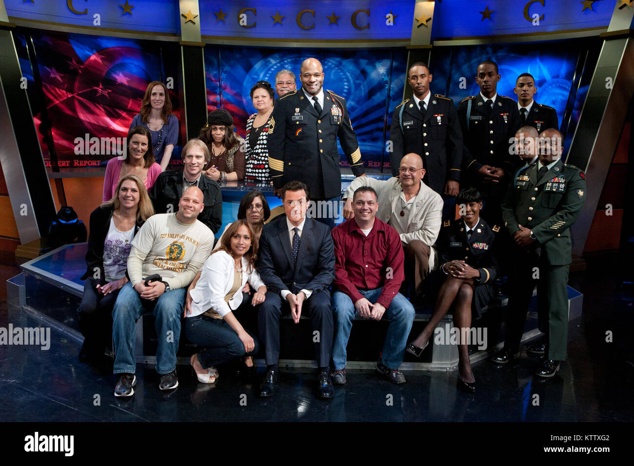 Soldiers and Family members of the 727th Military Police Law and Order Detachment, the 369th Sustainment Brigade and 1st Battalion, 69th Infantry Regiment gather around Stephen Colbert, host of The Colbert Report after his conversation with first lady Michelle Obama, on the first anniversary promoting Joining Forces,  a national initiative led by the first lady and Dr. Jill Biden that mobilizes all sectors of society to give our service members and their families the opportunities and support they have earned. Stock Photo