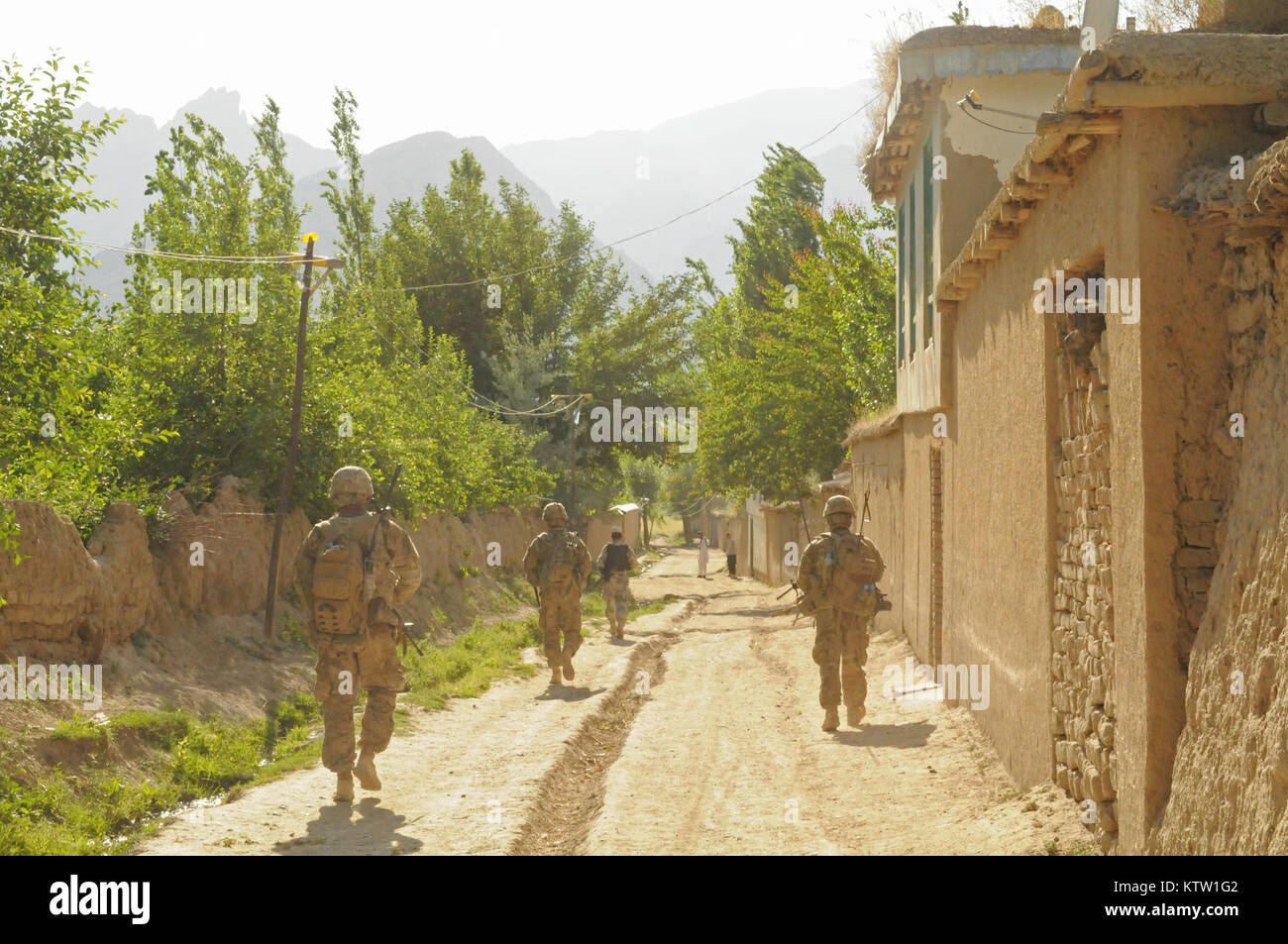 A soldier of the 6th Kandak Afghan Border Police leads Soldiers of the 5th Zone Security Force Assistance Team assigned to the 37th Infantry Brigade Combat Team, down a dirt road after completing a medical civic action program for the Afghan females in Khwahan, Badakhshan Province, Afghanistan, June 3, 2012.  (37th IBCT photo by Sgt. Kimberly Lamb) (Released) Stock Photo