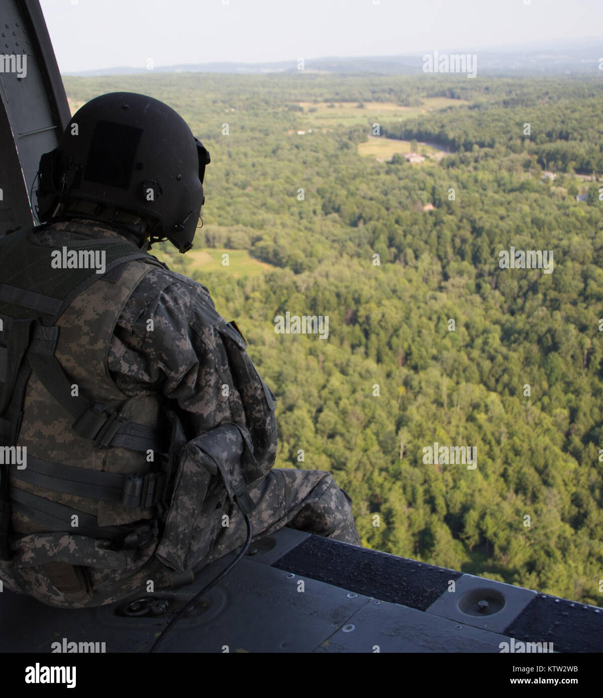 MARCY, NY-- A crew member looks out from a UH-60 Medevac Blackhawk from Company F, 1-169th General Support Aviation Battalion of the New York  Army National Guard during medical evacuation training here on Thursday July 12.  Photo by SPC Harley Jelis, HHC 42nd CAB, NYARNG Stock Photo