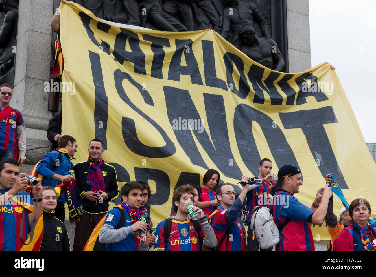 Barca fans in Trafalgar Square before the kick-off of the Champions League Final between FC Barcelona and Manchester United. A large banner goes up 'Catalonia is not Spain' behind some football fans to make a political protest. Stock Photo