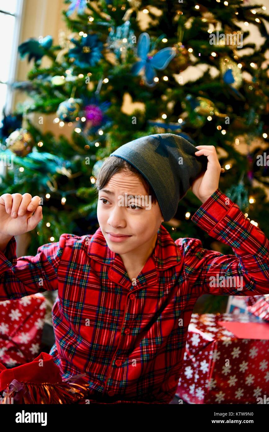 Teen boy in flannel pajamas on Christmas day Stock Photo
