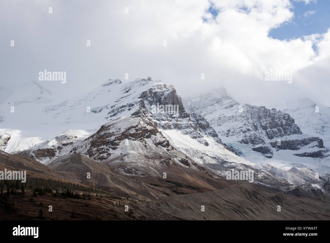 ATHABASCA GLACIER, ALBERTA, CANADA. - SEPTEMBER 2015: Fog consumes a mountain that is part of the famed Athabasca Glacier. Stock Photo