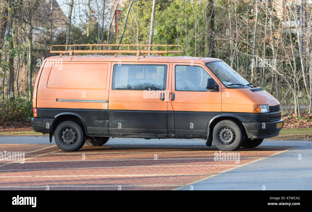 Classic camper van standing on a parking place Stock Photo - Alamy