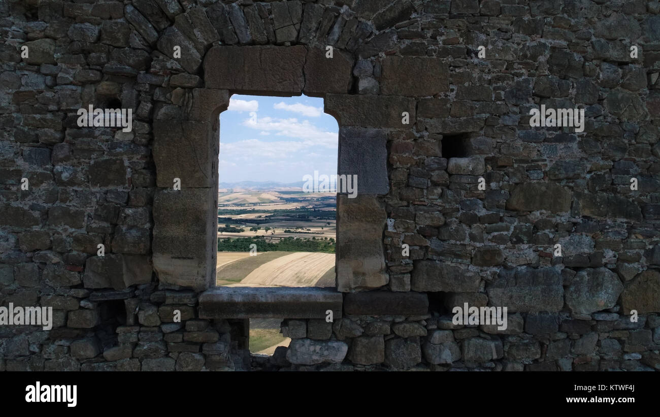 Window on the facade of a medieval tower in Montecorvino (Volturino, Italy). Stock Photo