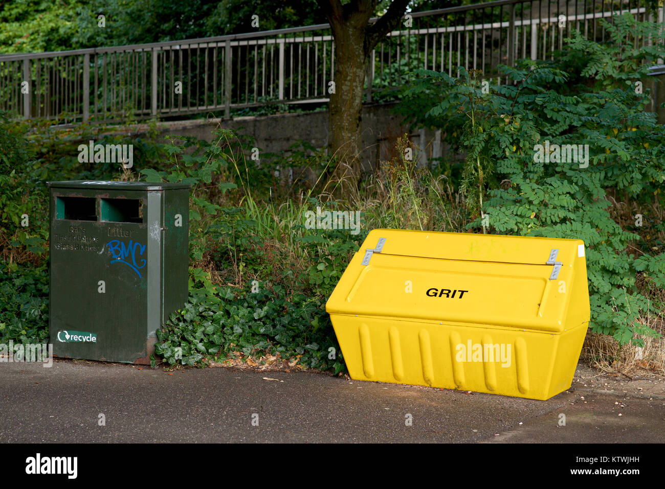 Yello Grit bin and Green refuse bin by a footpath Stock Photo