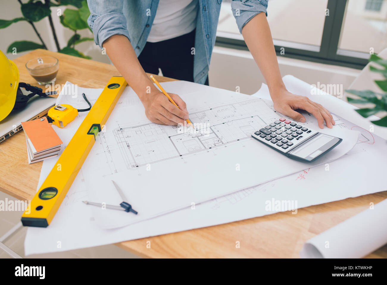 architect man working with laptop and blueprints,engineer inspection in workplace for architectural plan,sketching a construction project ,selective f Stock Photo