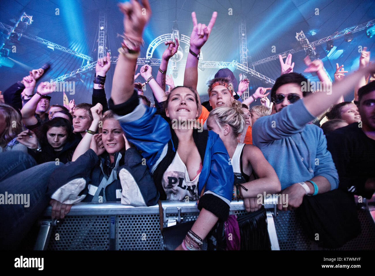 Energetic music fans and festival goers have a great time front row at a concert with the British electronic music duo Chase & Status who performs live concert Roskilde Festival 2011. Denmark, 30/06 2011. Stock Photo