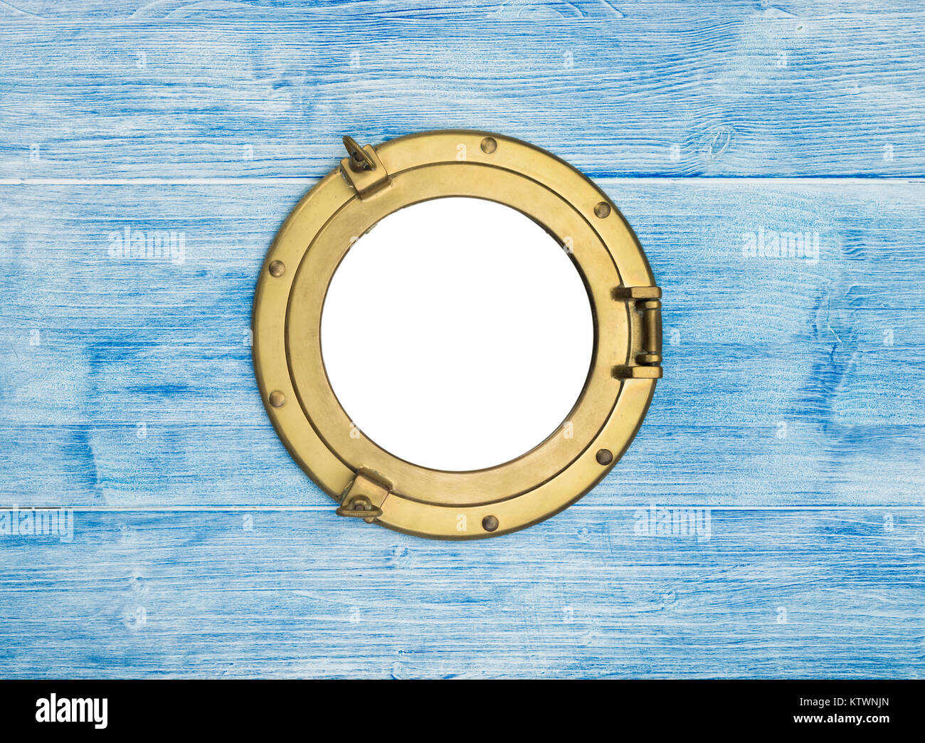 Vintage brass porthole in blue painted wooden wall, window isolated with clipping path Stock Photo