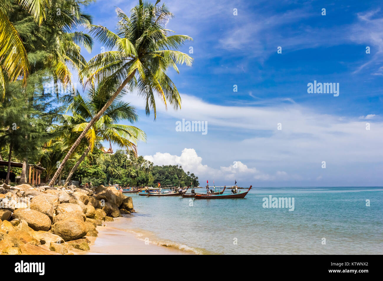Boats moored on tropical beach with palm trees, southern end of Bang ...