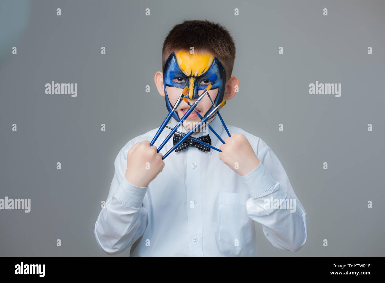 A small Kazakh boy with an aqua make-up on his face. Drawing on the face Stock Photo