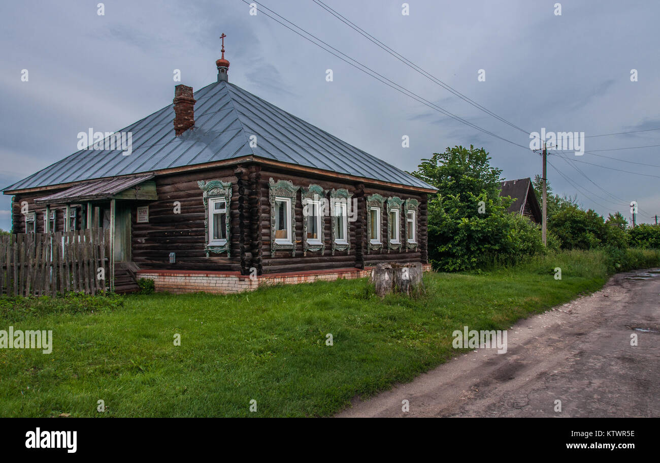 Old log house in a small village, converted into a Russian Orthodox church. Stock Photo